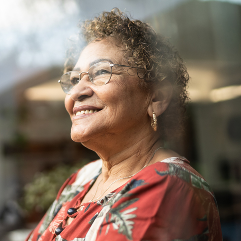 woman smiling looking out a window