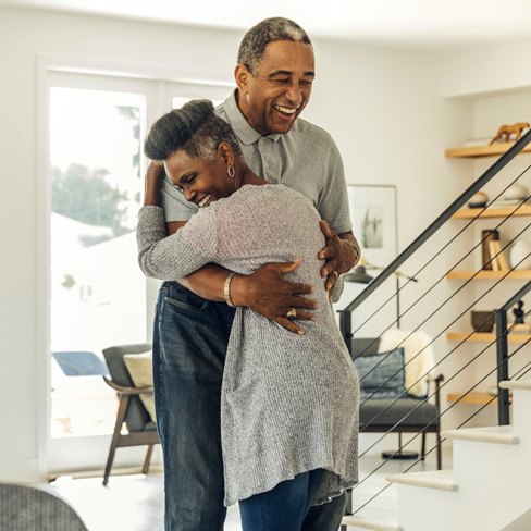 two people hugging indoors