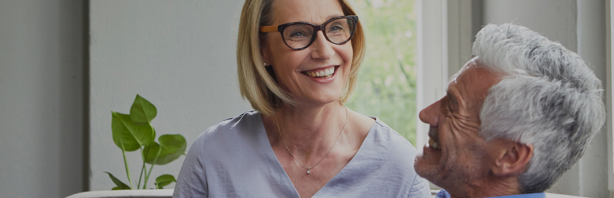 Man smiling at woman with glasses