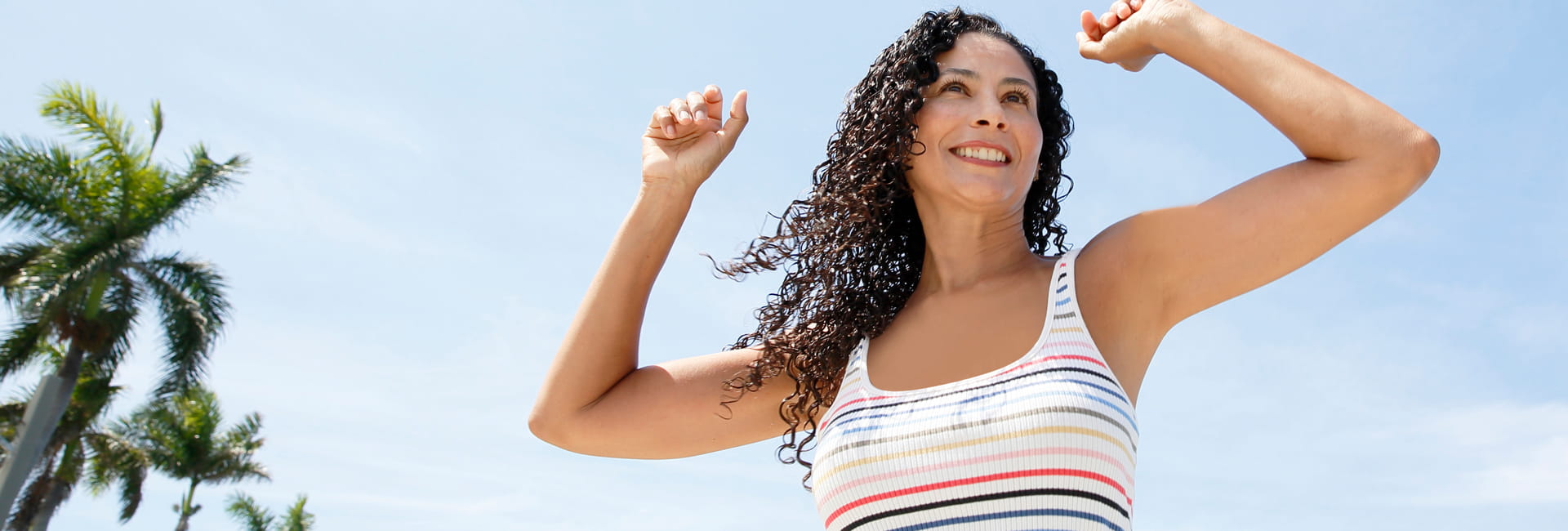 Woman with her arms raised triumphantly