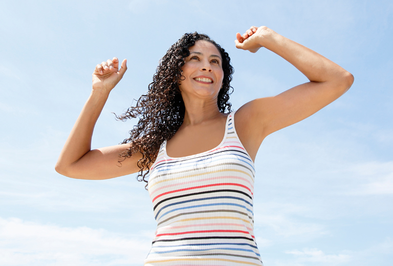 Woman with her arms raised triumphantly