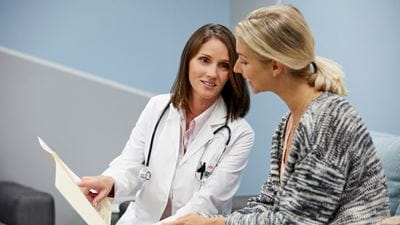 Doctor explaining to woman patient