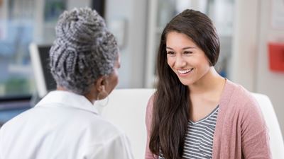 Female patient speaking to female doctor