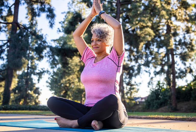 woman stretching with legs crossed