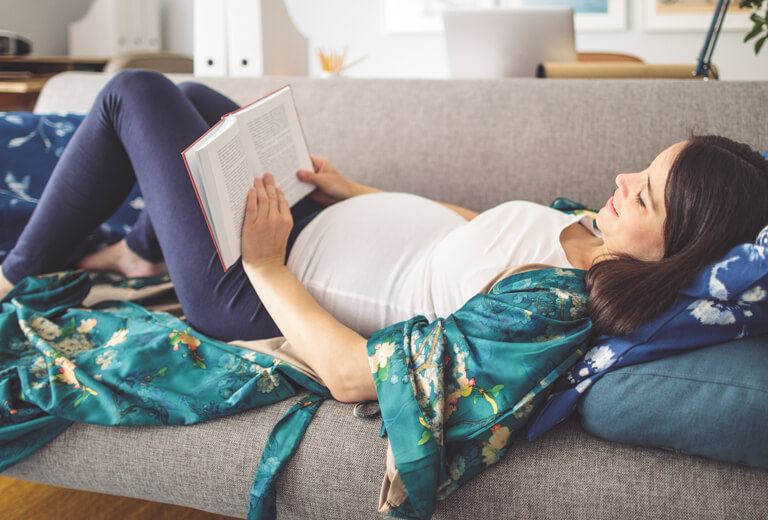 pregnant woman reading a book