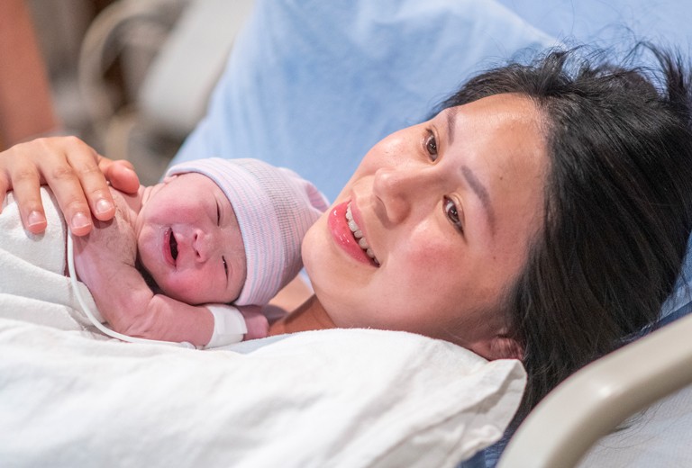 woman with newborn on chest