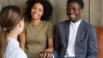 Couple holds hands at counseling