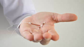 Doctor holding an IUD