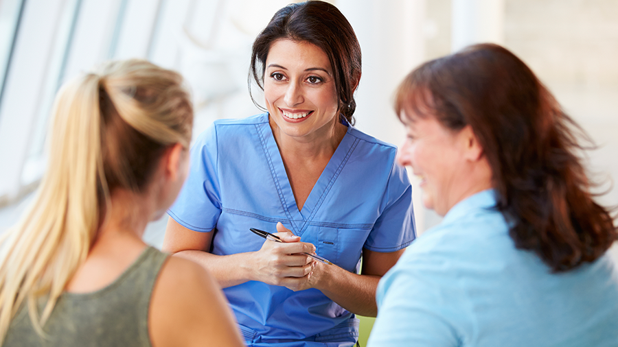 Mother and daughter consulting with daughter's care provider